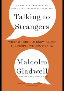 Cover of the book "Talking with Strangers" by Malcolm Gladwell. The cover is orange with white conversation bubbles. 